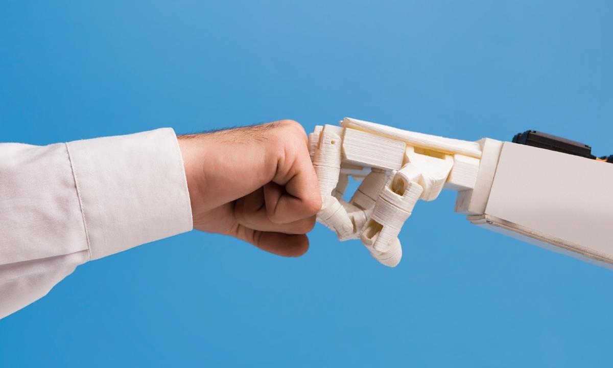 man giving a fist bump to an AI controlled robotic fist