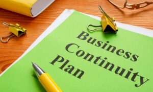a green piece of paper with the words "business continuity planning" written on it