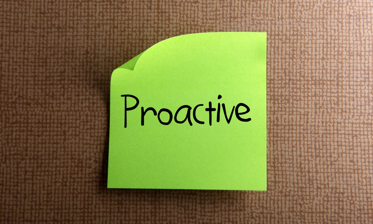 a green sticky note with the word "proactive" written on it